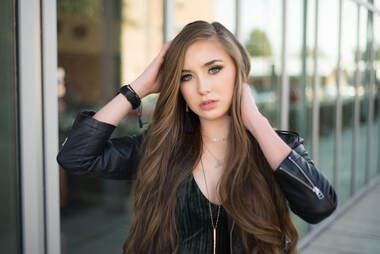 Teen girl posing, leather jacket