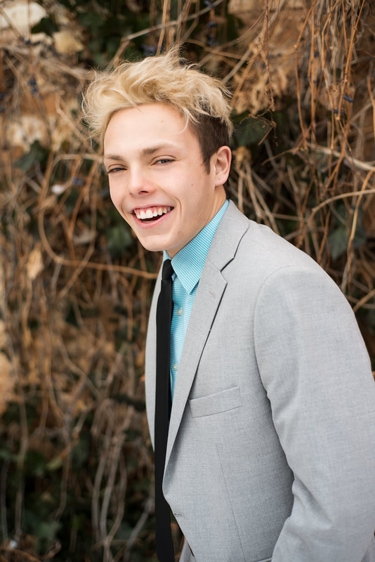 Teen boy smiling, gray suit
